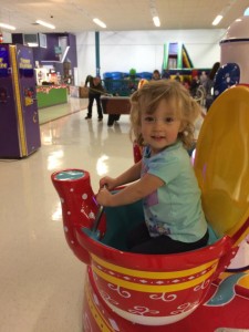 Daughter Nadya rides the teacup. 