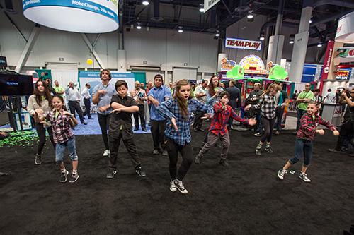 A flash mob of selfie-taking dancers broke out at PayRange's booth during the final day of the Amusement Expo, highlighting the company's focus on smart phone technology and Millennials 