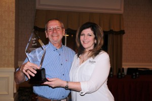 Mary Lavine presents Larry McEntire with the NDA Hall of Fame award.