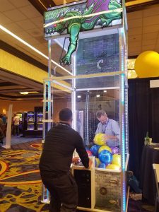 Anthony "Funky Cold" Medina - sales rep and quality control for Benchmark - plays for the big prize, AAMA topper Chris Felix, at the Brady Starburst booth at this year's GAMOA trade show.