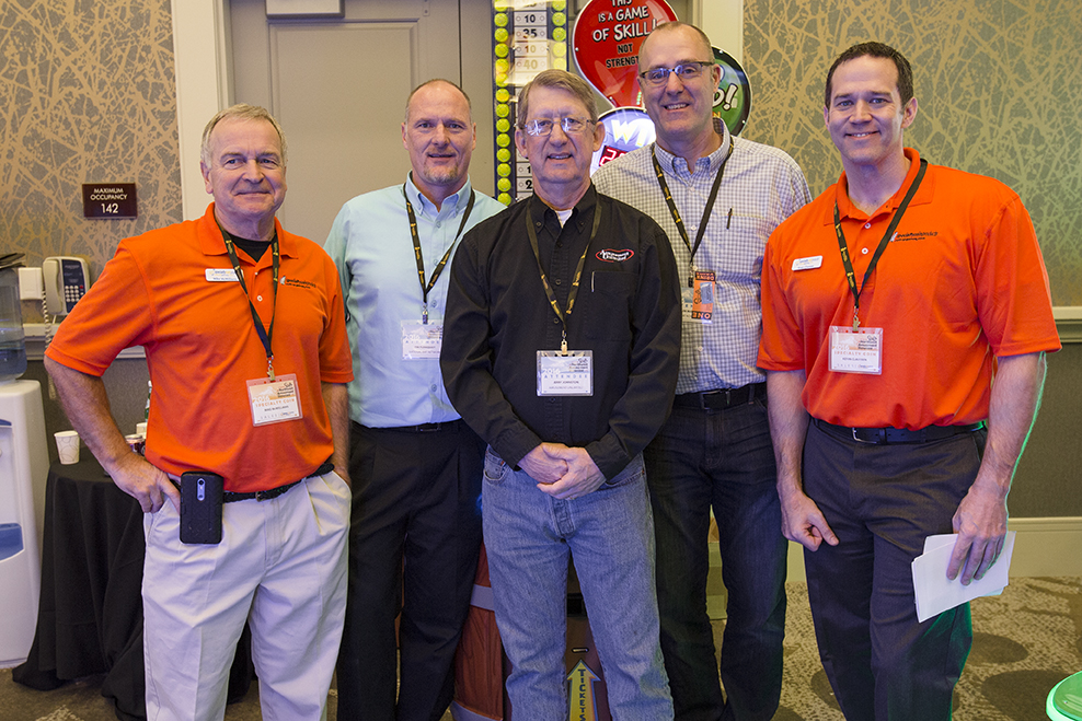 AMOA representatives Tim Turnquist, Jerry Johnston and Jim Marsh posing with Specialty Coin's President Mike McWilliams (far left) and Kevin Claussen (far right).