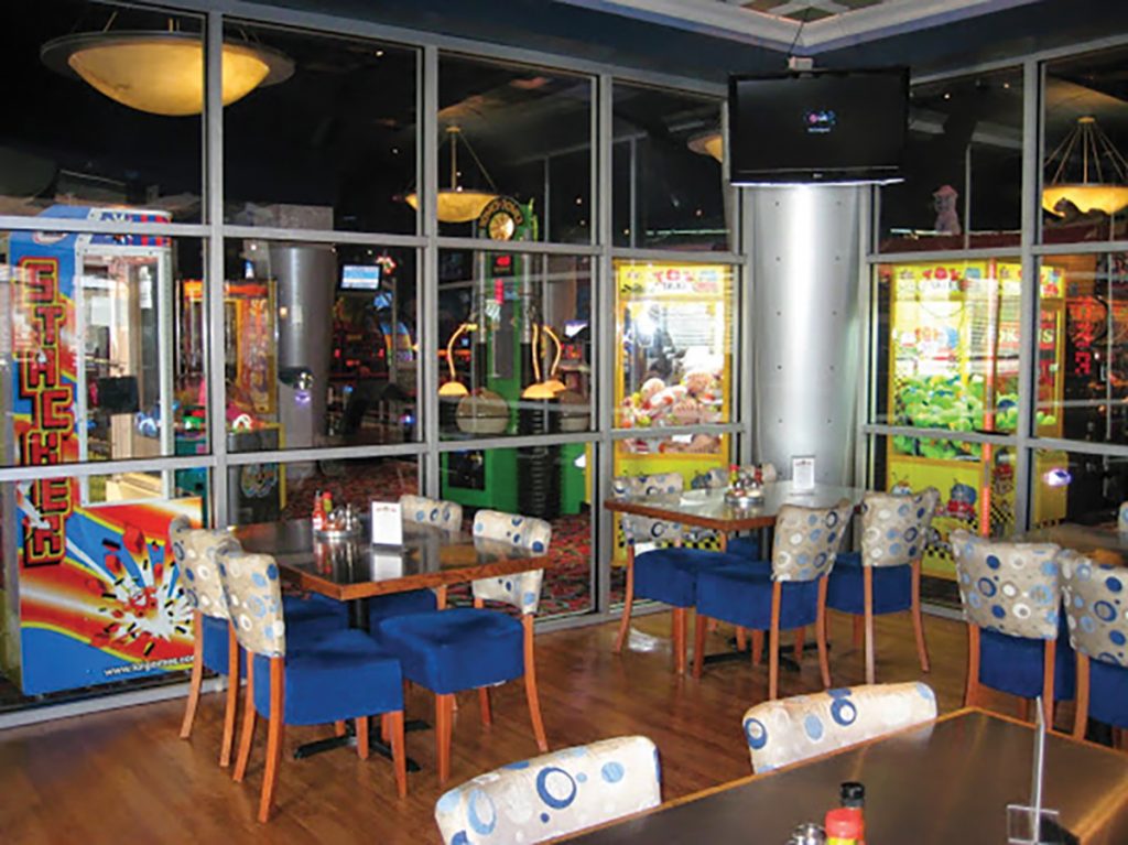 The see-through walls at Ultimate California Pizza enables guests to enjoy dinner and drinks while still seeing the fun going on in the game room (all with much less noise).