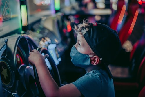 Masked child playing video games