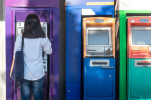 woman using ATM - Adobe Stock