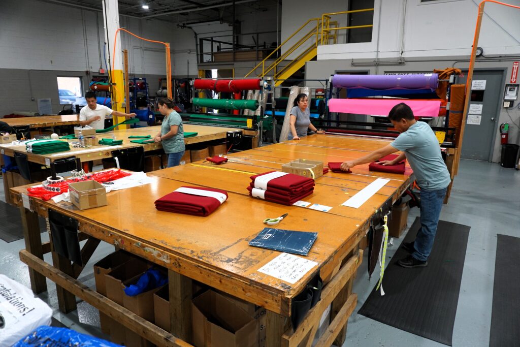 Championship LLC cover story - 1023 - staff cutting cloth